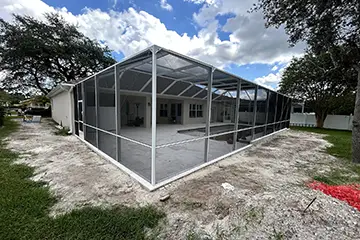 White mansard pool enclosure by East Coast Aluminum